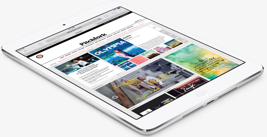 Top view of an iPad mini2, angled to the right, with screen showing news webpage in Safari